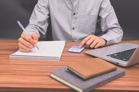 Business people sit at work and check documents At the desk in the roomの写真素材