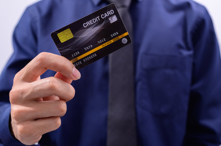 Business people hold credit cardsの写真素材
