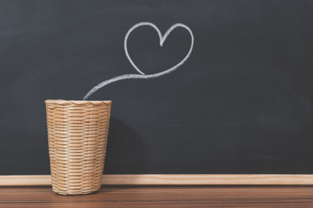 A kettle and a heart shape on the blackboardの写真素材