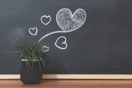 Plant pots and heart shapes on the blackboardの写真素材
