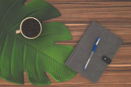 Notebook and coffee mug On the deskの写真素材