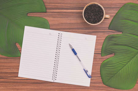 Notebook and coffee mug On the deskの写真素材