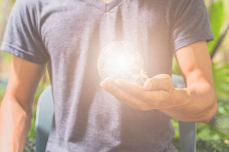 idea of a man holding a light bulbの写真素材