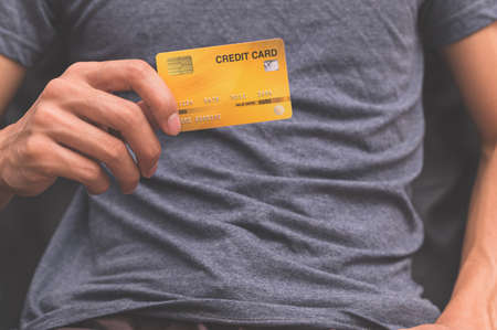A man holding a credit card on his handの写真素材
