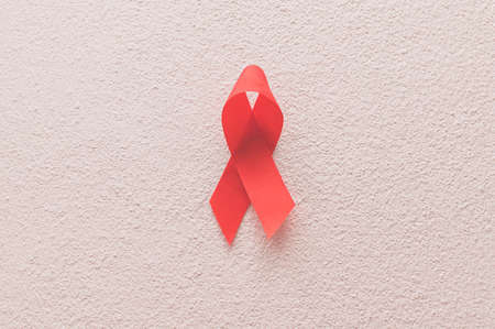 Red ribbon symbolizes world health dayの写真素材