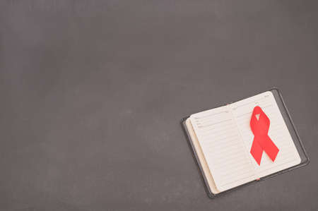 Red ribbon symbolizes world health dayの写真素材