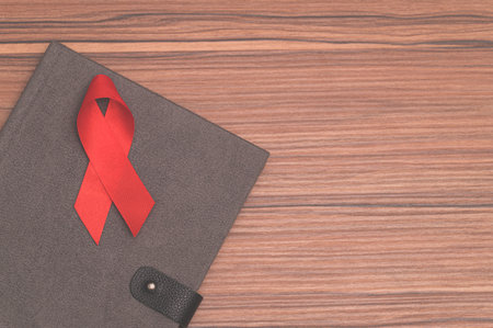 Red ribbon symbolizes world health dayの写真素材