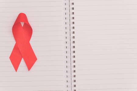Red ribbon symbolizes world health dayの写真素材