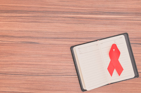 Red ribbon symbolizes world health dayの写真素材