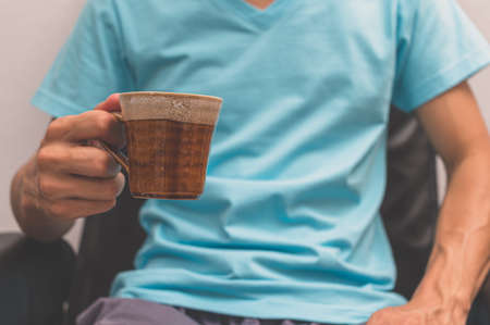 A man holding a coffee cupの写真素材