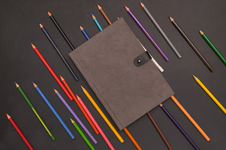 Book and colored pencils Back to school and education concept