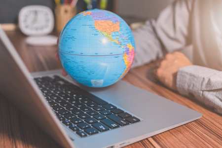 Use a computer to work to make money to communicate around the worldの写真素材