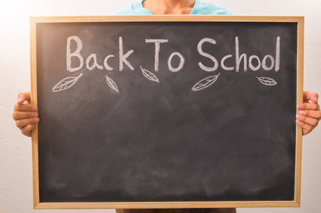 Holding black paper write the word back to schoolの写真素材