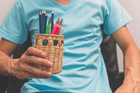 People holding pencils and pensの写真素材
