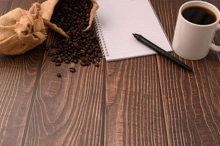 Coffee and a notebook are at your desk.の写真素材