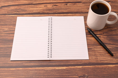 Coffee and a notebook are at your desk.