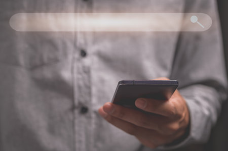 Humans use smartphones to find information.の写真素材