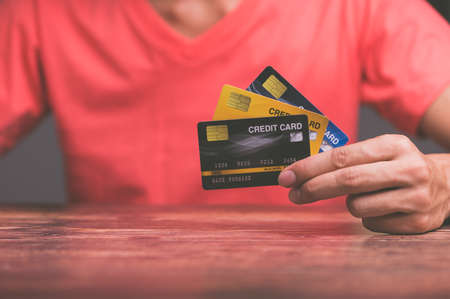Business people hold credit cardsの写真素材