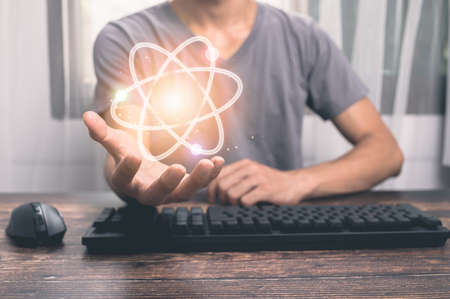 Man holding atom molecule icon illustrationの写真素材