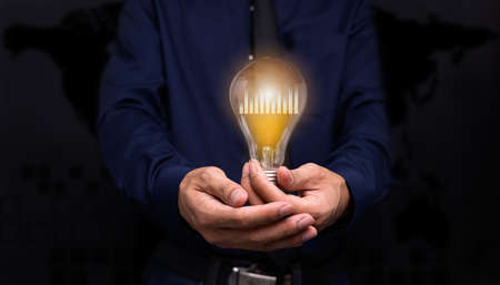 Handheld concept light bulb bar graph idea stock investmentの写真素材