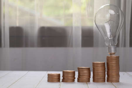 coins stacked together investment ideas stocks financial growth light bulb ideasの写真素材