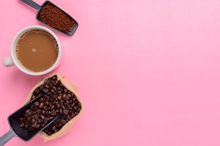 Coffee mug and coffee beans on a pink background