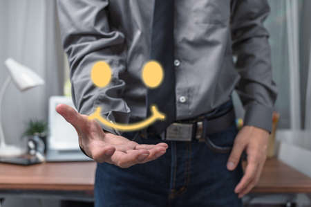 Businessman showing satisfaction with service with smileの写真素材