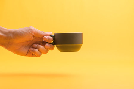 Hand holding a coffee cup, drinking coffee to give energy.の写真素材