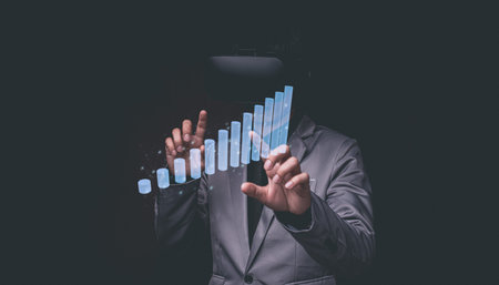 Businessman using Virtual Reality Metaverse glasses to virtual world showing bar graph business growthの写真素材