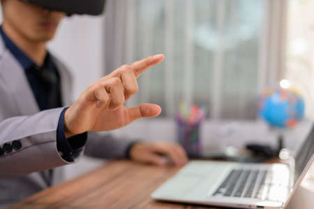 Businessman using Virtual Reality glasses _VR Augmented Reality Metaverse on virtual world.の写真素材