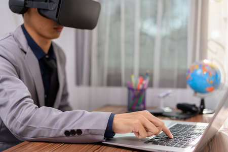 Businessman using Virtual Reality glasses _VR Augmented Reality Metaverse on virtual world.の写真素材