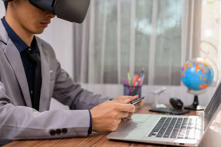 Businessman is using VR glasses to work. Virtual world.の写真素材