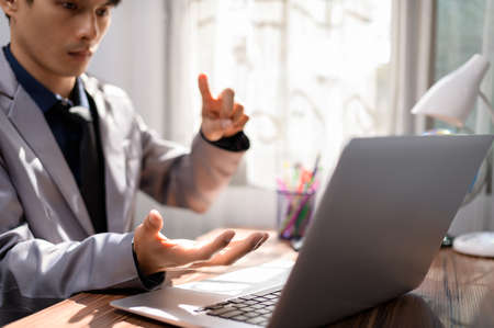 businessman working in front of a notebook computer at a deskの写真素材