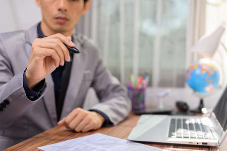businessman working in front of a notebook computer at a deskの写真素材