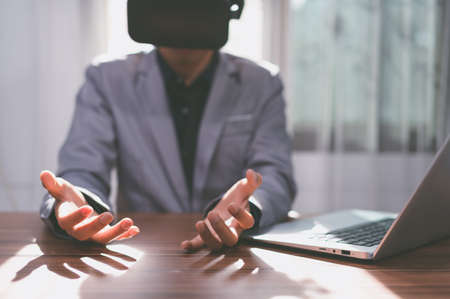 Use Virtual Reality glasses to work with the virtual metaverse world.の写真素材