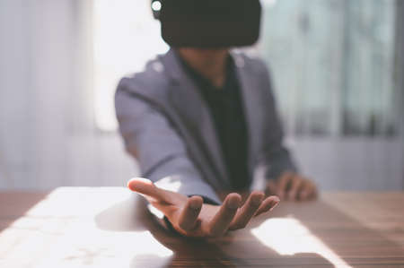Businessmen are using virtual reality glasses in the virtual metaverse world.の写真素材