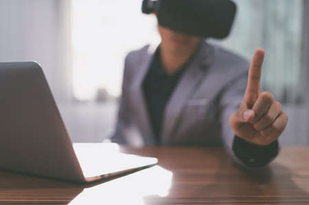 Businessmen are using virtual reality glasses in the virtual metaverse world.の写真素材