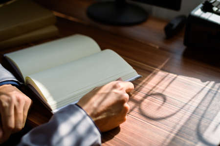 businessman reading and writing book at workの写真素材