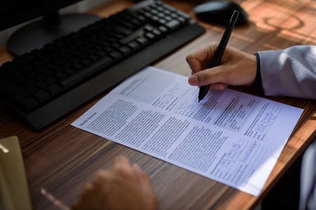 businessman reading and writing documents at workの写真素材