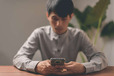 People are using smartphones to communicate, work, play games, watch movies, listen to music.の写真素材