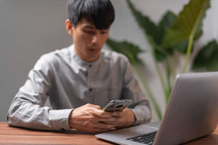 People are using smartphones to communicate, work, play games, watch movies, listen to music.の写真素材