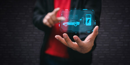 Choosing an electric vehicle. electric car choice. pointing at symbol on charging machine. electric car productionの写真素材