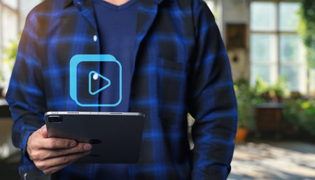 A person holding a tablet displays a media play icon, representing leisure activities like watching...