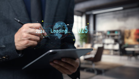 A businessman utilizes a tablet to illustrate global transition concepts, featuring futuristic loading graphics and data visualization in a modern office setting.の写真素材