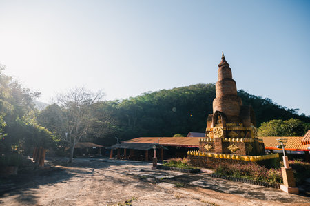Explore a stunning ancient temple on a serene landscape, surrounded by lush greenery and bathed in sunlight, perfect for spiritual reflection and travel.の写真素材