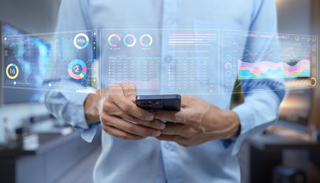 A person interacts with a smartphone in a modern office while augmented reality data visualizations display various metrics and insights, illustrating the blend of technology and business analytics.の写真素材