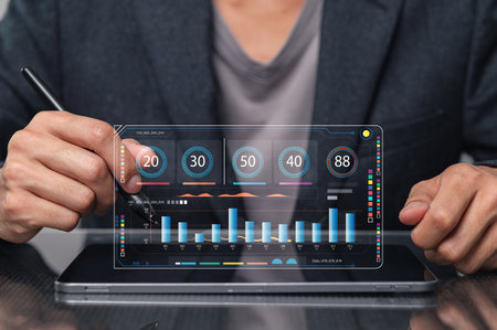 A professional analyzing data on a digital tablet with a transparent interface, showcasing intricate visualizations and metrics for effective decision-making.の写真素材