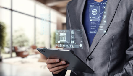 A modern businessman holds a tablet, engaging with digital shopping features like online stores and export options. Capture the essence of contemporary commerce technology.の写真素材