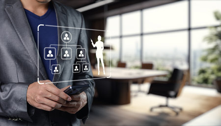 Explore the modern organization chart diagram displayed on a smartphone in a stylish office. This visual showcases digital resources and effective communication in a corporate environment.の写真素材