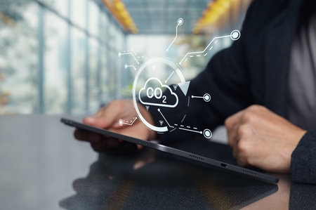 A digital representation of carbon dioxide reduction efforts displayed on a tablet. This image illustrates innovative technology focused on environmental sustainability and climate action.の写真素材